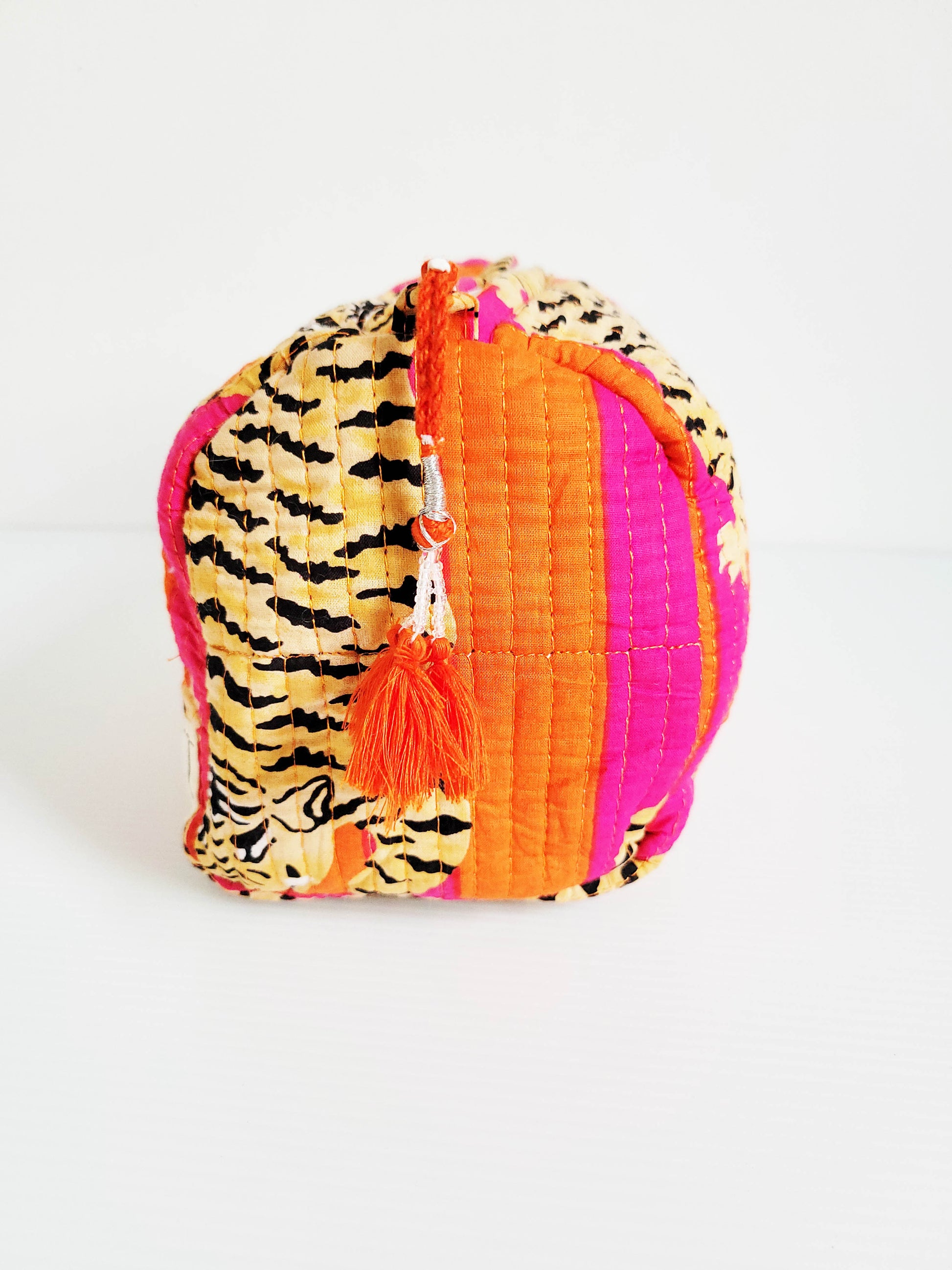 Side view of orange and pink leopard tote.