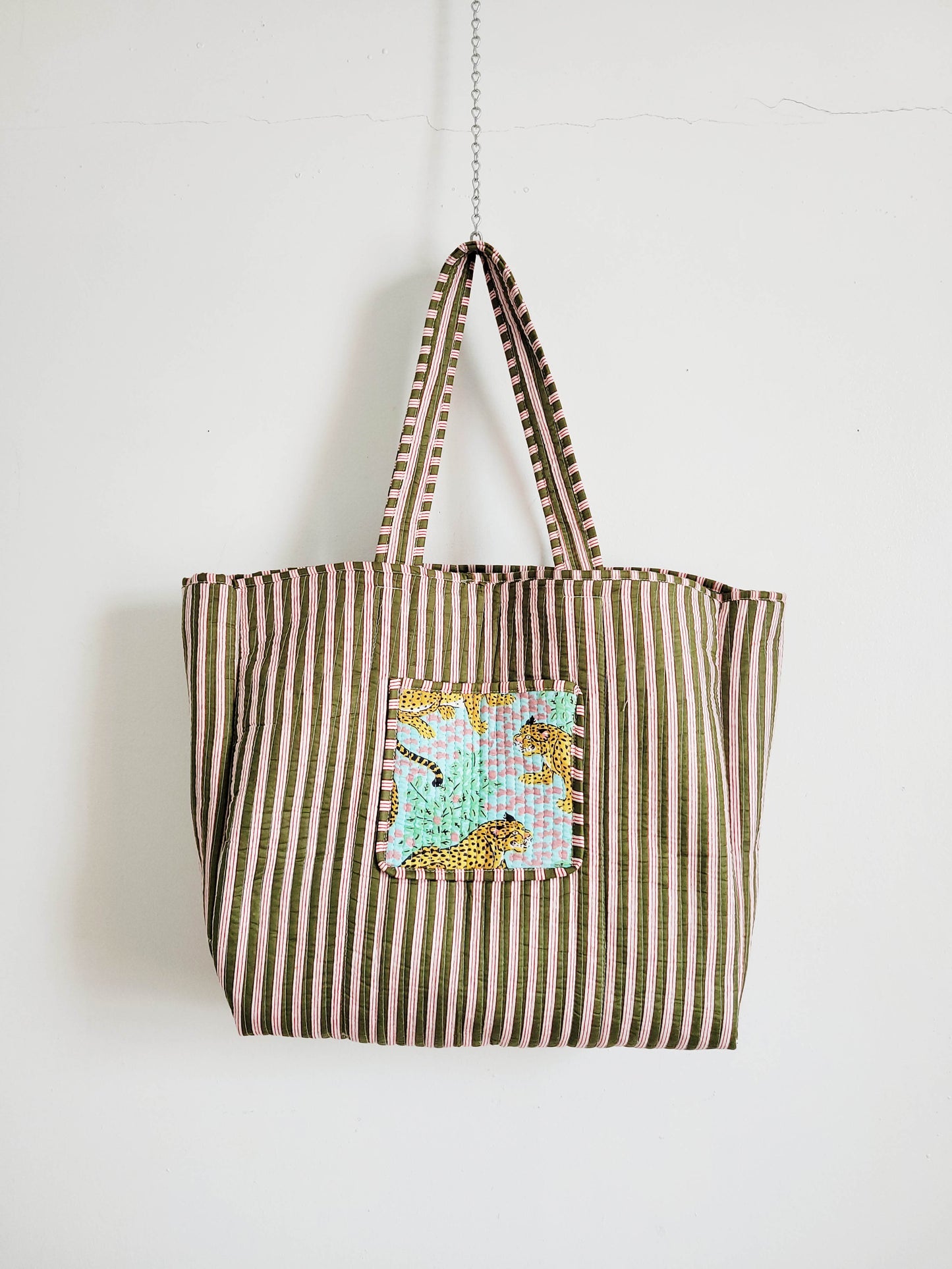 Cat in relaxed pose on soft surface.