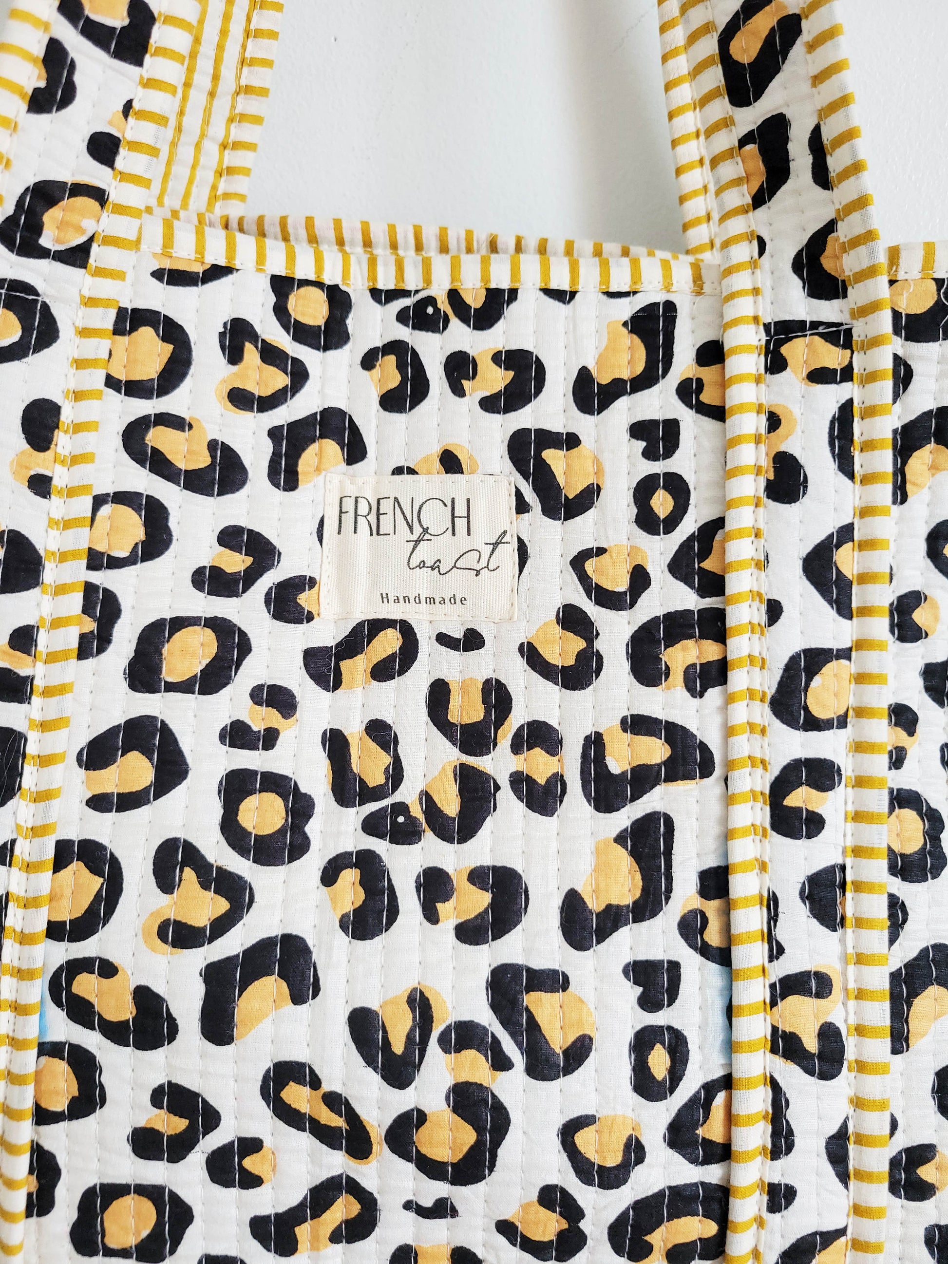 Dark pink makeup bag displayed on table.