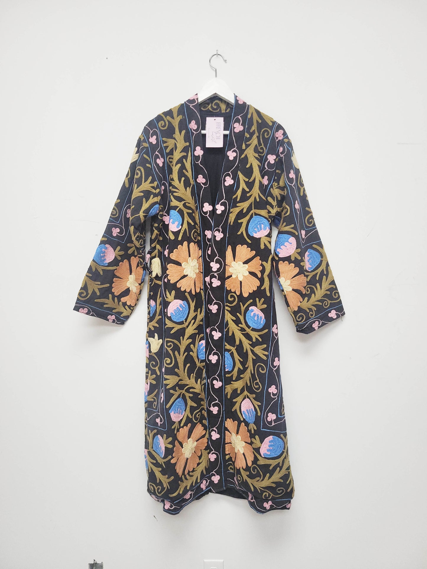 Floral patterned jacket hanging on a white background