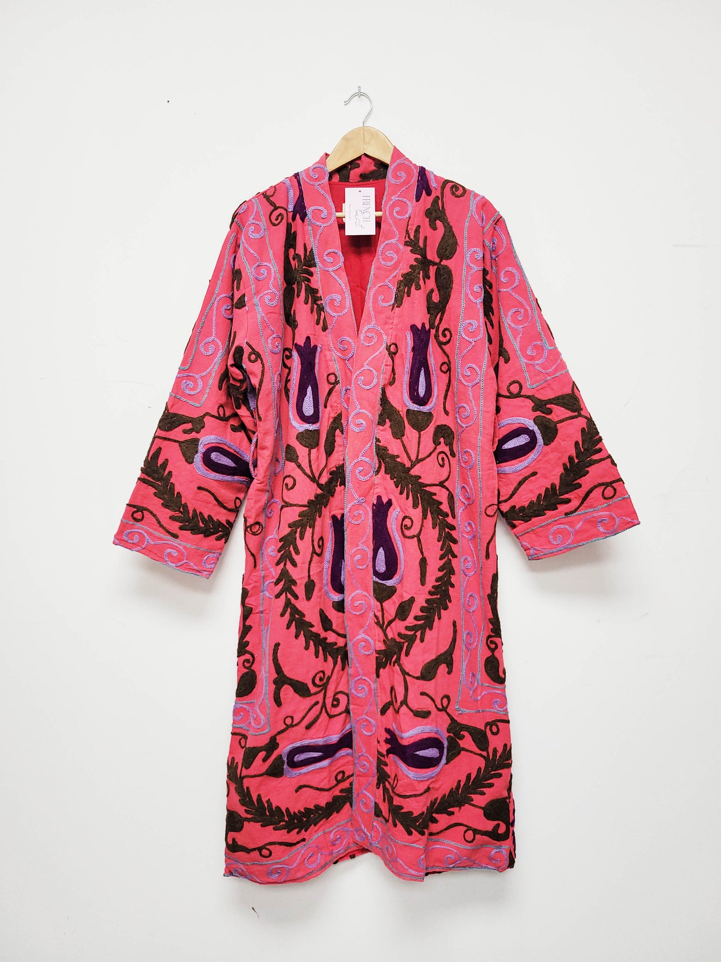 Pink long jacket with brown abstract pattern on a white background